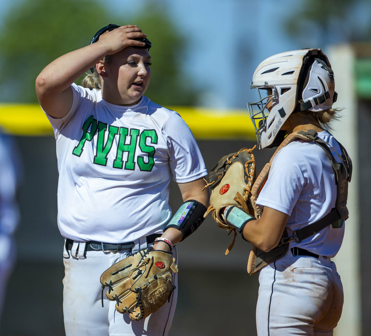 Palo Verde pitcher Bradi Odom (13) confers with catcher Madi Malloy while facing Centennial bat ...