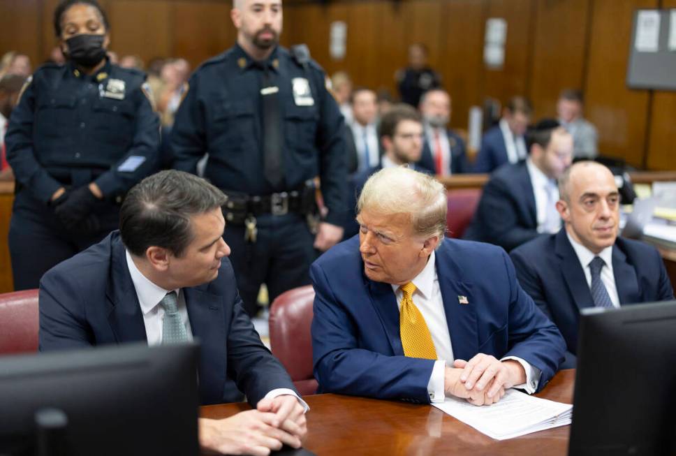 Former President Donald Trump, center, talks with his attorneys Todd Blanche and Emil Bove duri ...