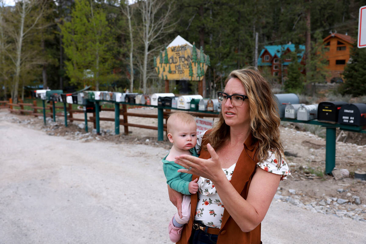 Jessie Thompson holds her daughter Margot, 7 months, while talking to a reporter in their Old T ...