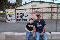 Second grader Isaac Armas and his dad, Anthony, sit at the closed Lundy Elementary School in th ...