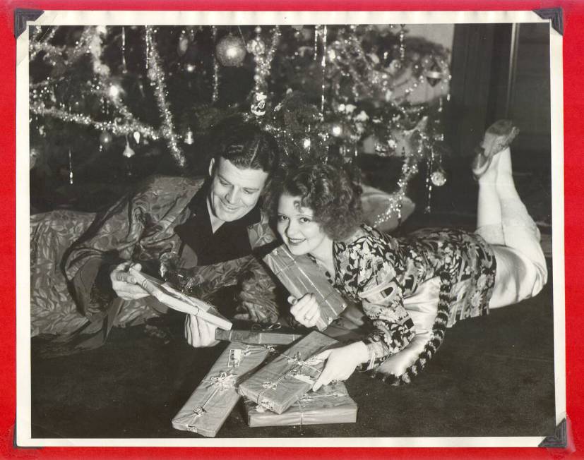 Clara Bow and husband Rex Bell opening Christmas presents under the tree at Walking Box Ranch i ...