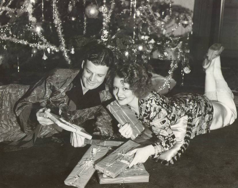 Clara Bow with husband Rex Bell opening Christmas presents at Walking Box Ranch in the early 19 ...