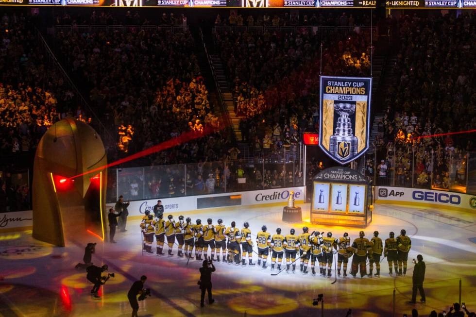 Golden Knights players gather during the raising of the 2023 Stanley Cup Championship banner be ...