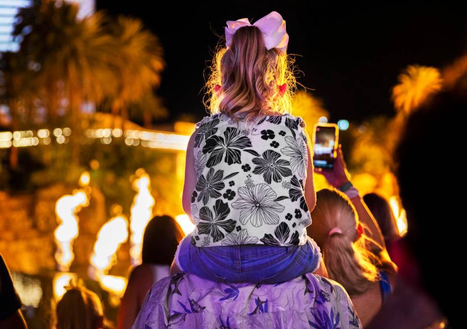 People on the Strip watch the first volcano show since the opening of the The Mirage earlier in ...