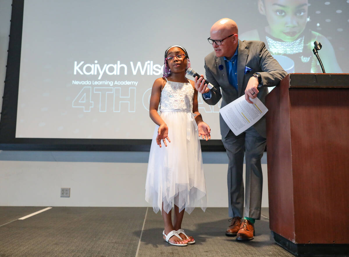 Fourth grade winner Kaiyah Wilson answers a question from Chet Buchanan, professional radio and ...