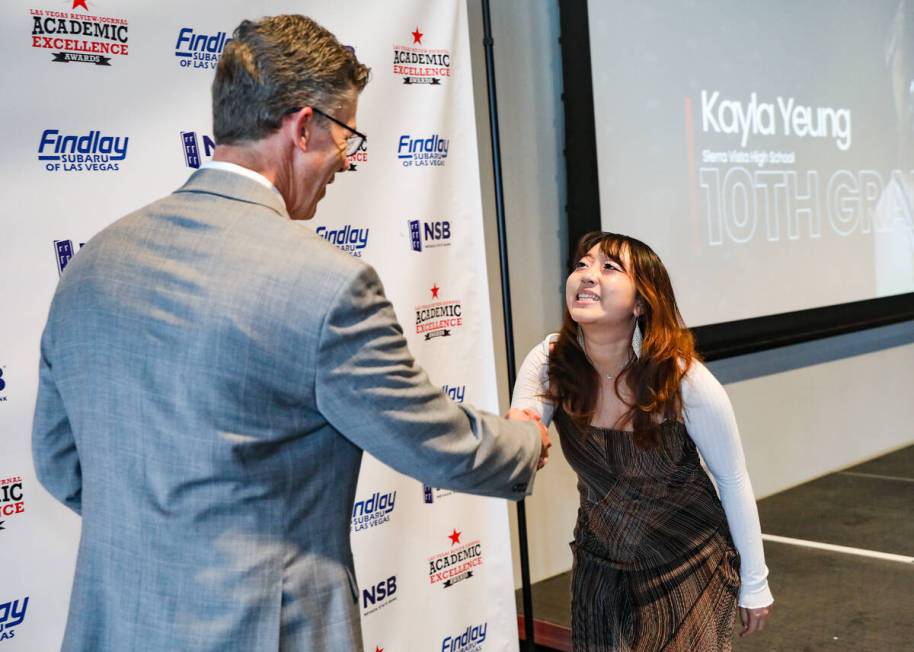 Review-Journal’s Executive Editor Glenn Cook greets Kayla Yeung, a 10th grade student at Sier ...