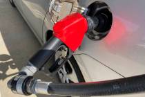 A car is shown at a gas pump, Friday, Jan. 21, 2022, at a gas station. (AP Photo/Wilfredo Lee)