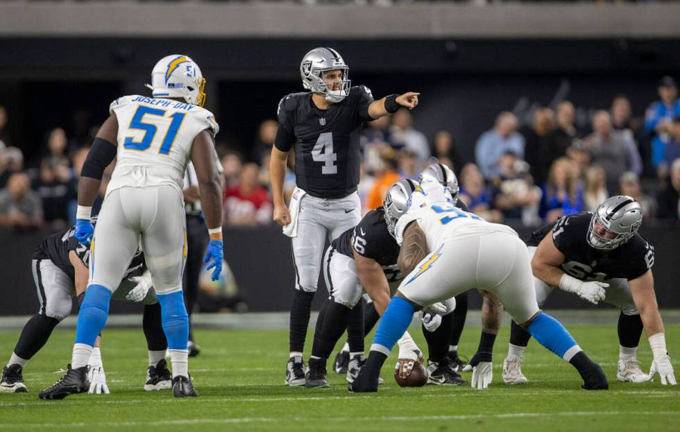 Raiders quarterback Aidan O'Connell (4) audibles at the line of scrimmage during the first half ...