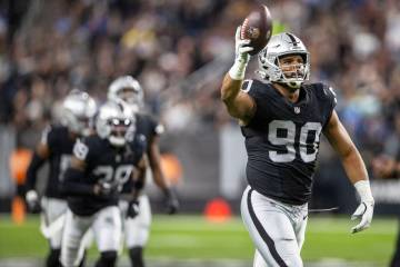 Raiders defensive tackle Jerry Tillery (90) holds up the football after forcing a fumble during ...