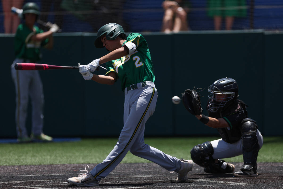 Bishop Manogue Preston Travers (2) swings and misses while at bat against Palo Verde during a C ...