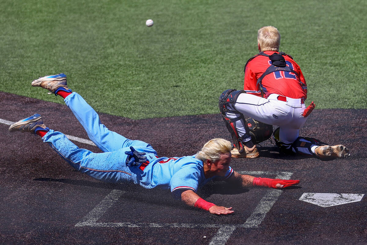 Reno outfielder Dawson Planeta (5) slides safely into home plate while Coronado catcher AJ Stal ...