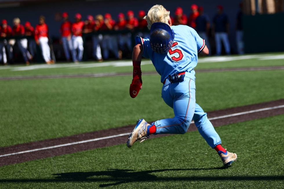 Reno outfielder Dawson Planeta (5) races toward home plate before scoring during a Class 5A bas ...