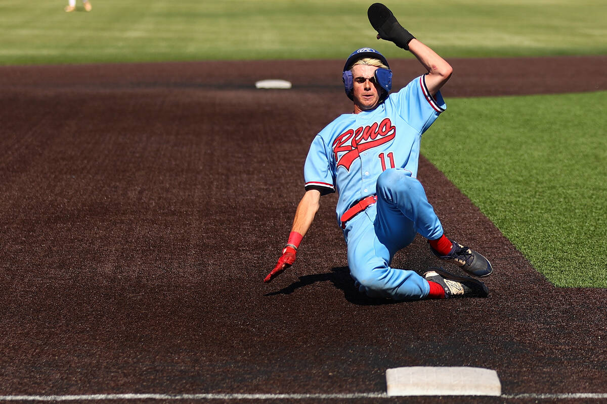 Reno pitcher Zackary Silverman (11) slides into third base during a Class 5A baseball state tou ...