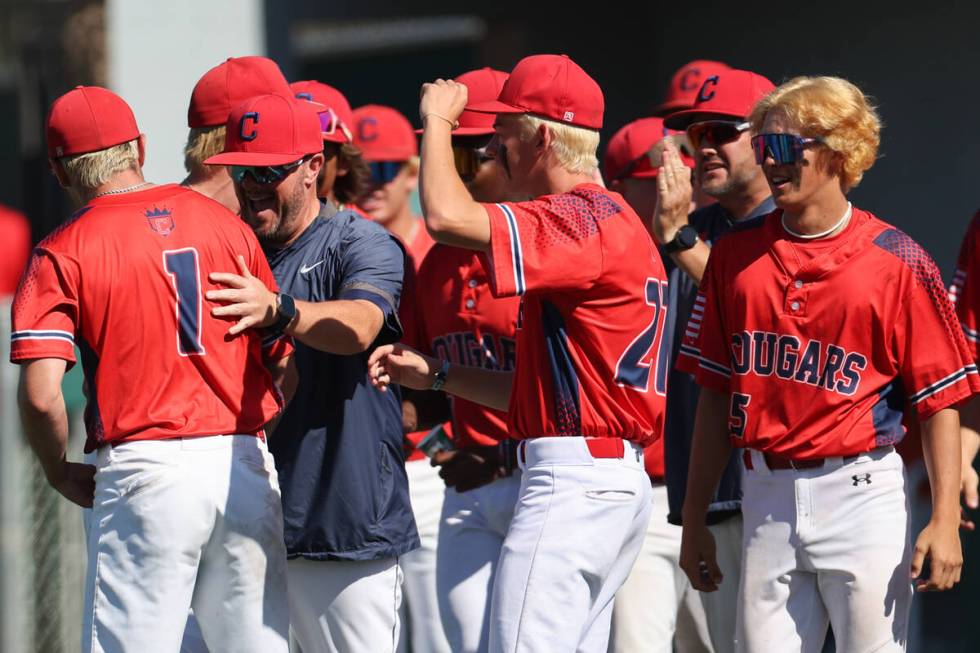 Coronado head coach Garrett Smith, second from left, congratulates closing pitcher Evan Festa ( ...