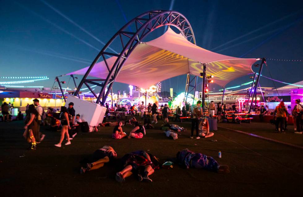 Festival attendees relax as the sun begins to rise during the second night of the Electric Dais ...