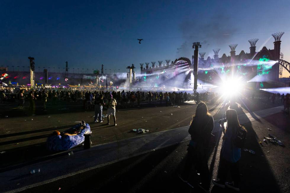 Festival attendees watch Kinetic Field as the sun begins to rise during the second night of the ...