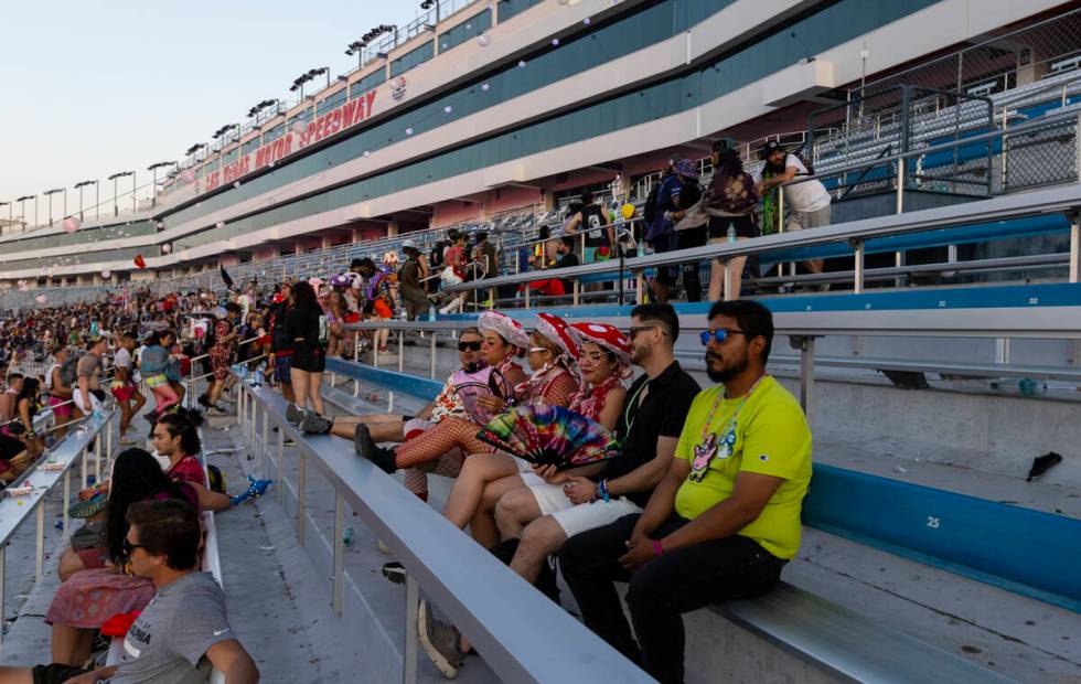 Festival attendees sit as others make their way towards the exits at sunrise on the close of th ...