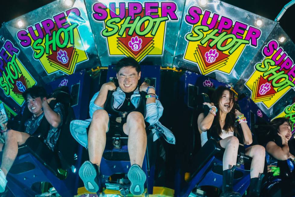 Festival attendees prepare for a drop on a ride during the second day of the Electric Daisy Car ...