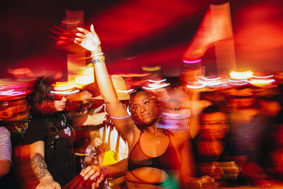 Festival attendees dance to a DJ set during the second day of the Electric Daisy Carnival at th ...