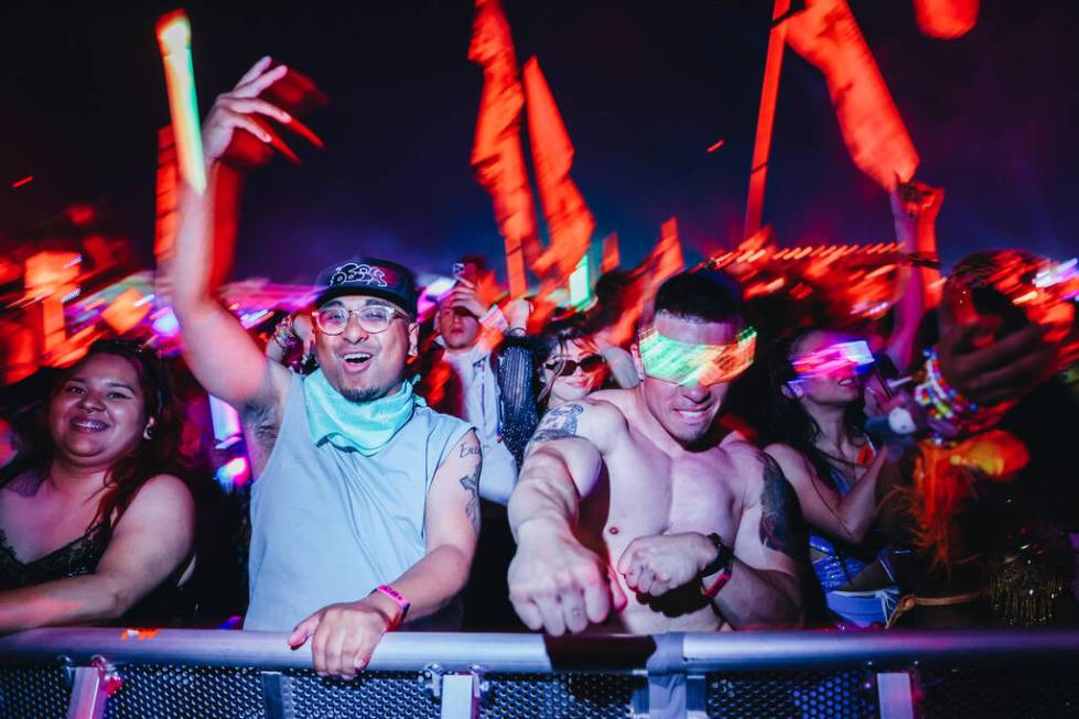 Festival attendees dance to a DJ set during the second day of the Electric Daisy Carnival at th ...