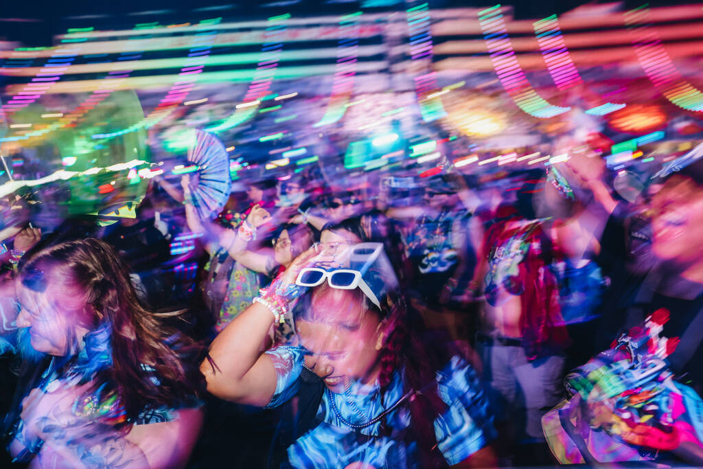 Festival attendees dance to a DJ set during the second day of the Electric Daisy Carnival at th ...