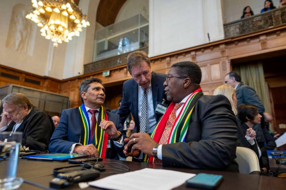 South Africa's agents Vusimuzi Madonsela, seated right, and Cornelius Scholtz, seated second le ...