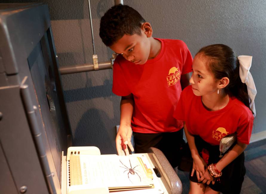 Goldfarb Elementary School students Thiago, left, and Daisy check out a display during a field ...