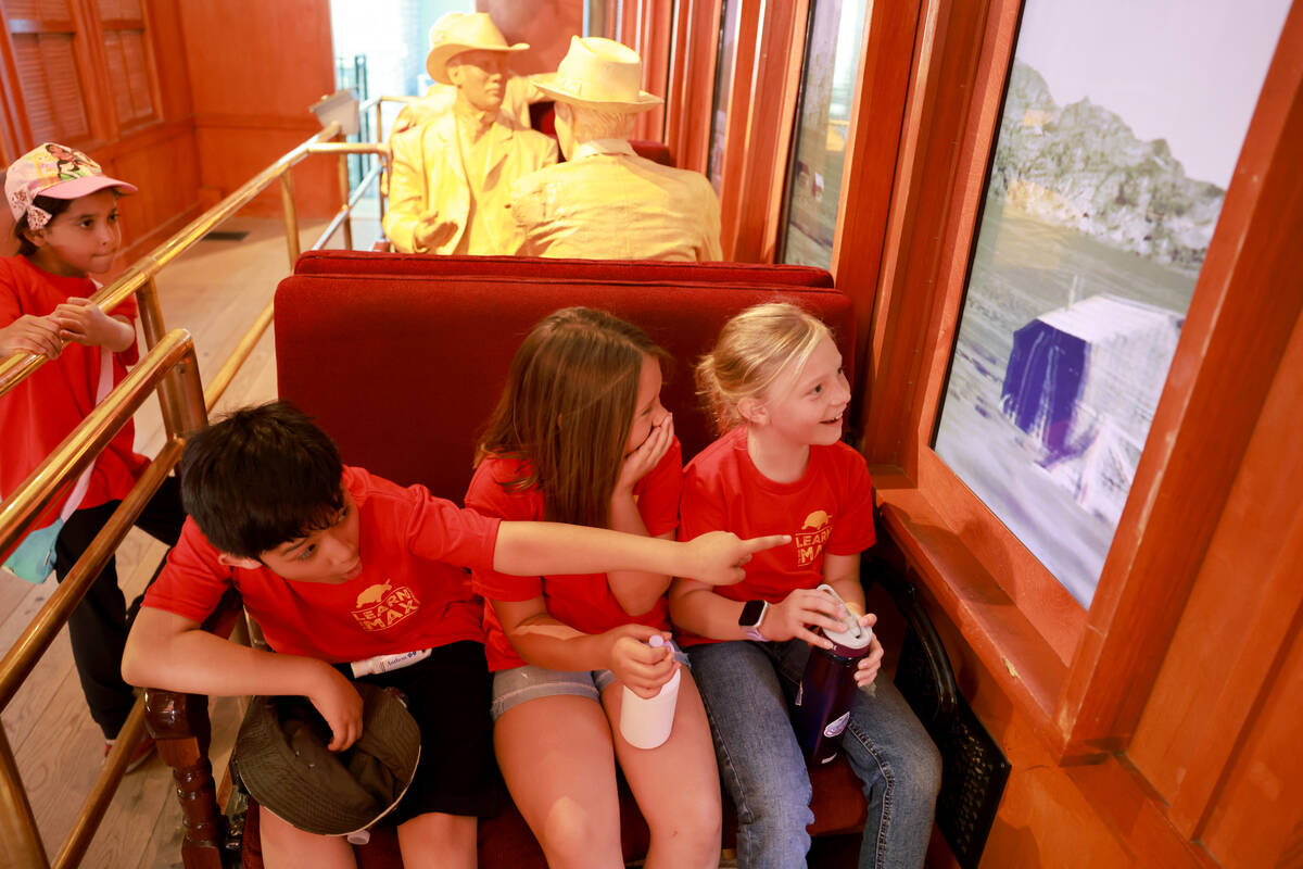 Goldfarb Elementary School students, from left, Oscar, Keira and Katie check out an early train ...
