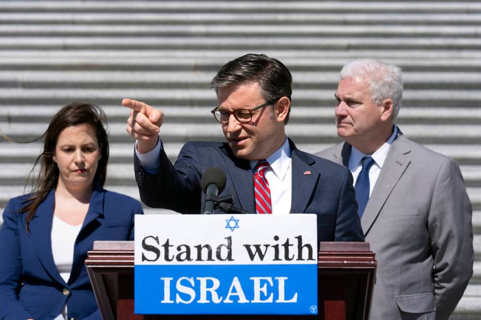 Speaker of the House Mike Johnson, R-La., center, flanked by GOP Conference Chair Elise Stefani ...