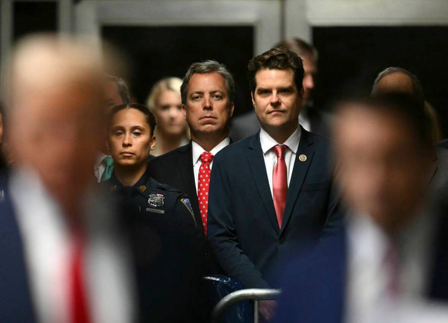 Reps. Andy Ogles, R-Tenn., left, and Matt Gaetz, R-Fla., listen as former President Donald Trum ...