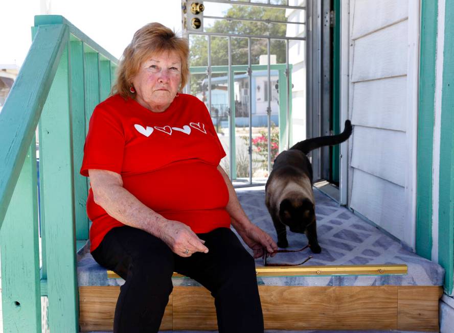 Risa Sykes poses for a photo with her cat, Hyme, in front of her home at the Palm Grove Senior ...
