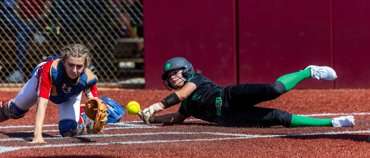 Palo Verde runner Taylor Johns (11) slides in safe at home against Coronado catcher Mary Lou Ts ...
