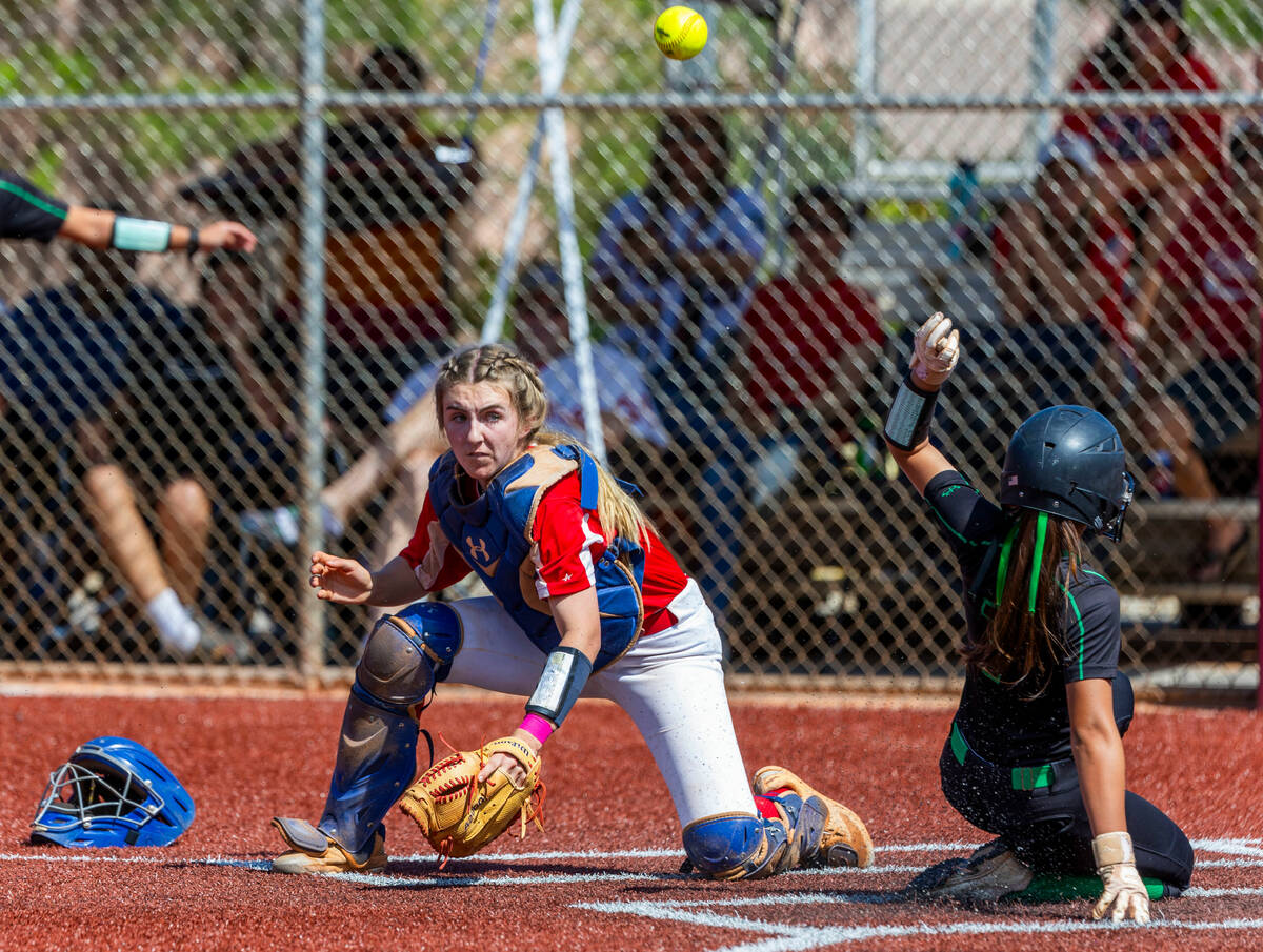 Coronado catcher Mary Lou Tsunis (10) looks to a deflected ball above as Palo Verde runner Alex ...