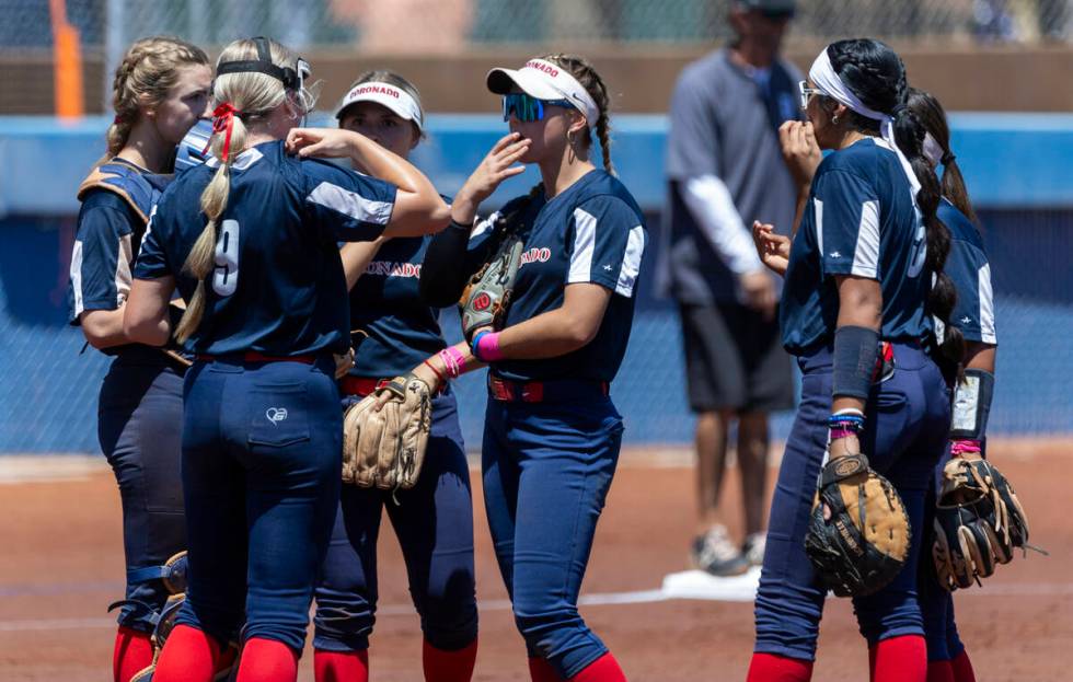 Coronado players come together on the mound for a talk against Douglas during the first inning ...