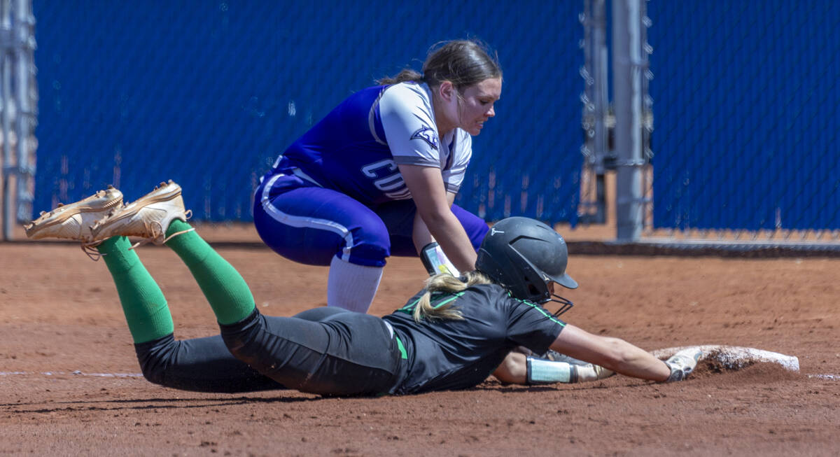 Palo Verde runner Taylor Johns (11) dives back to first base safely as Spanish Springs infielde ...