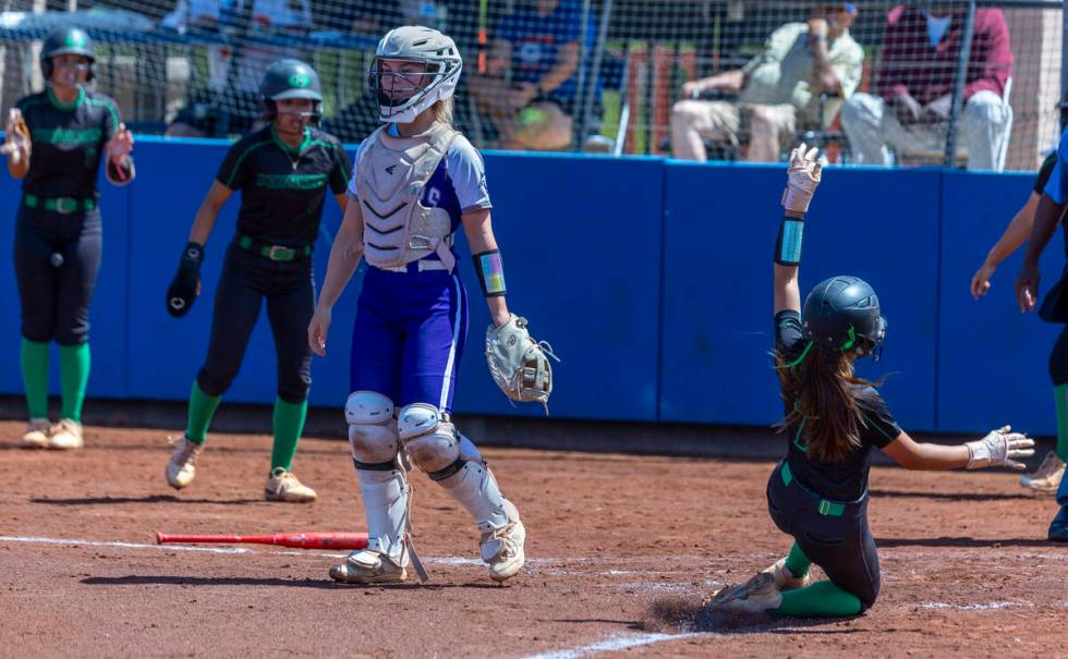 Palo Verde runner Alexis Kearnes (7) slides safely in to home as Spanish Springs catcher Brooke ...