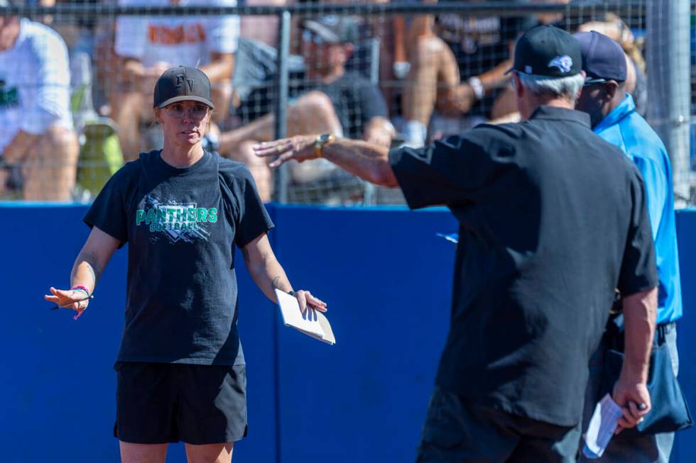 Palo Verde head coach Kelly Glass talks with an official and Spanish Springs head coach Jeff D ...