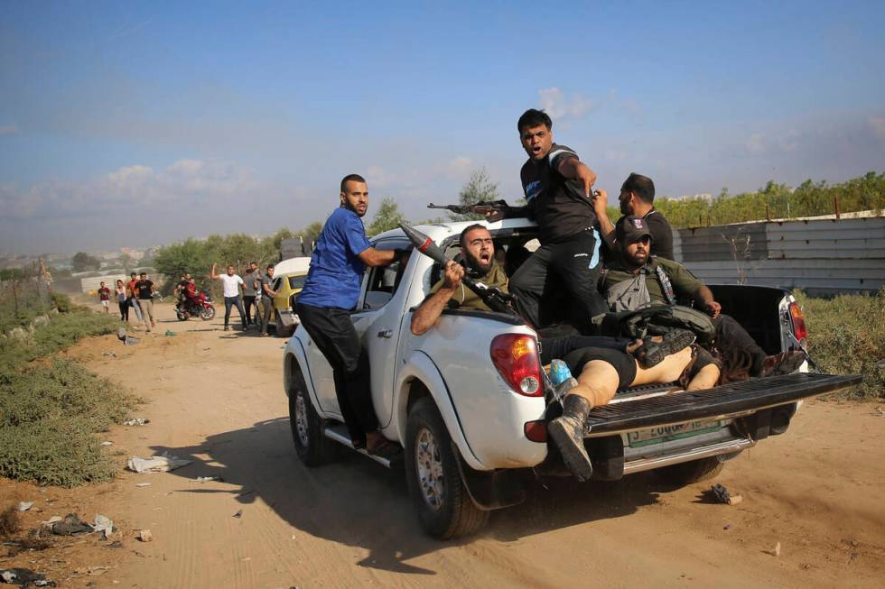 FILE - Palestinian militants drive back to the Gaza Strip with the body of Shani Louk, a German ...