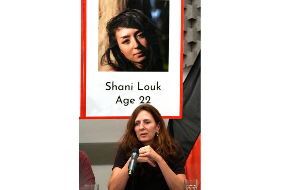 FILE - Ricarda Louk sits in front of a placard of her missing daughter Shani Louk Tuesday Oct. ...