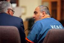 FILE - Attorney Ron Bamieh, left, listens to his client, Loay Abdelfattah Alnaji, a professor o ...