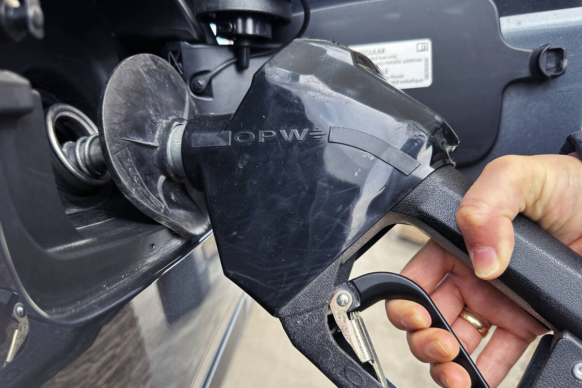 A customer pumps gas at a gas station in Mundelein, Ill., Feb. 8, 2024. (AP Photo/Nam Y. Huh, file)