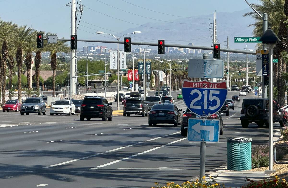 Vehicles pass through the intersection of Green Valley Parkway and Village Walk Drive on Sunday ...