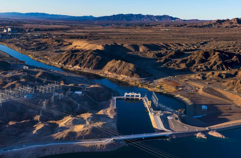 The sun rises on Davis Dam and beyond along the Colorado River on Thursday, Jan. 28, 2023, nort ...