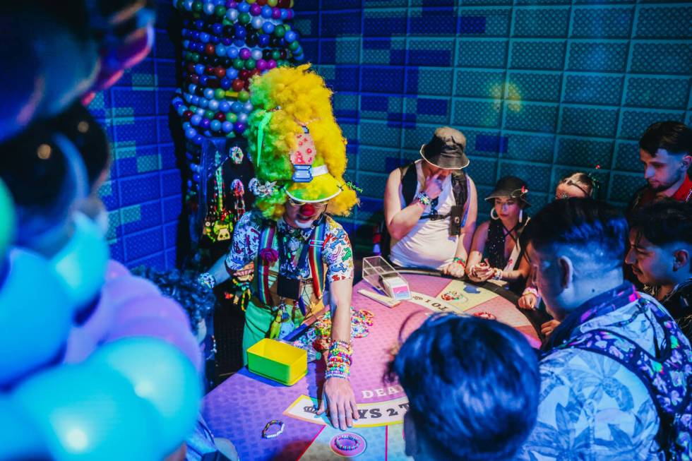 EDC attendees play poker with kandi bracelets during day one of Electric Daisy Carnival at the ...