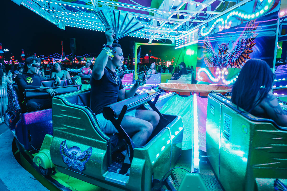 EDC attendees take in a festival ride during day one of Electric Daisy Carnival at the Las Vega ...