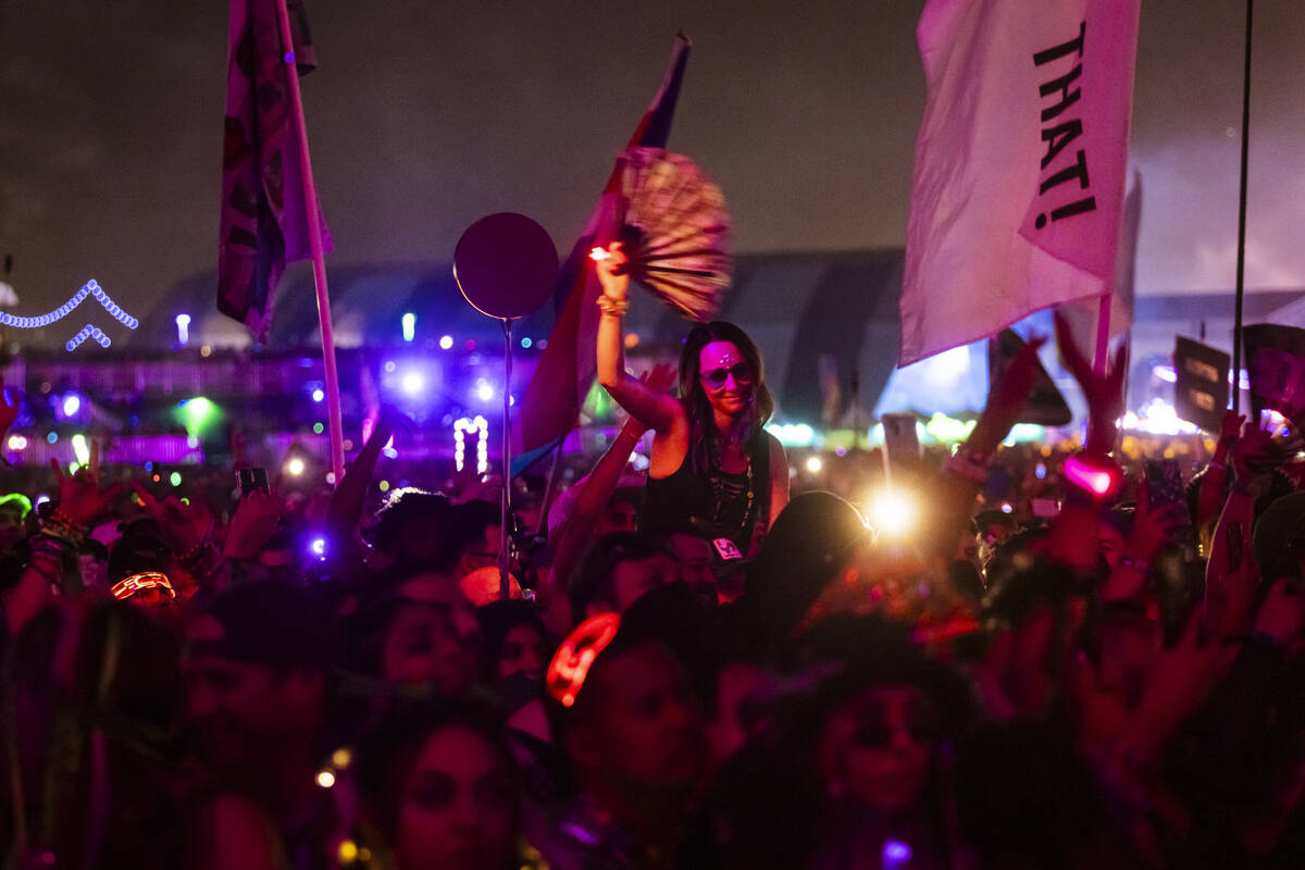 Attendees watch as David Guetta performs at the Kinetic Field stage during the first night of t ...