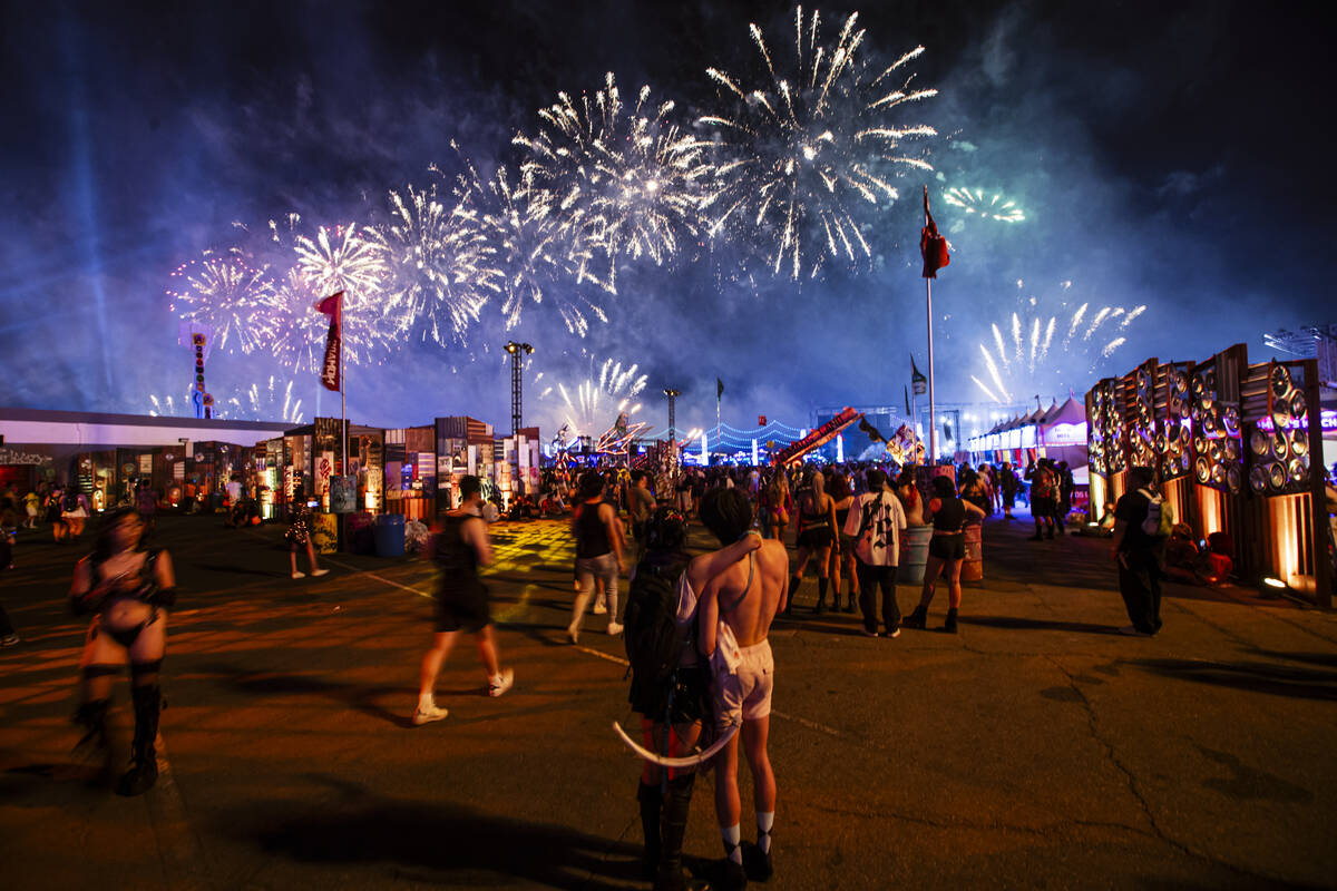 Attendees watch as fireworks go off during the first night of the Electric Daisy Carnival at th ...