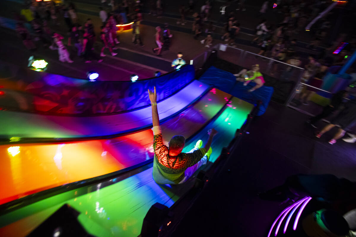 A festival attendee goes down a slide during the second night of the Electric Daisy Carnival at ...