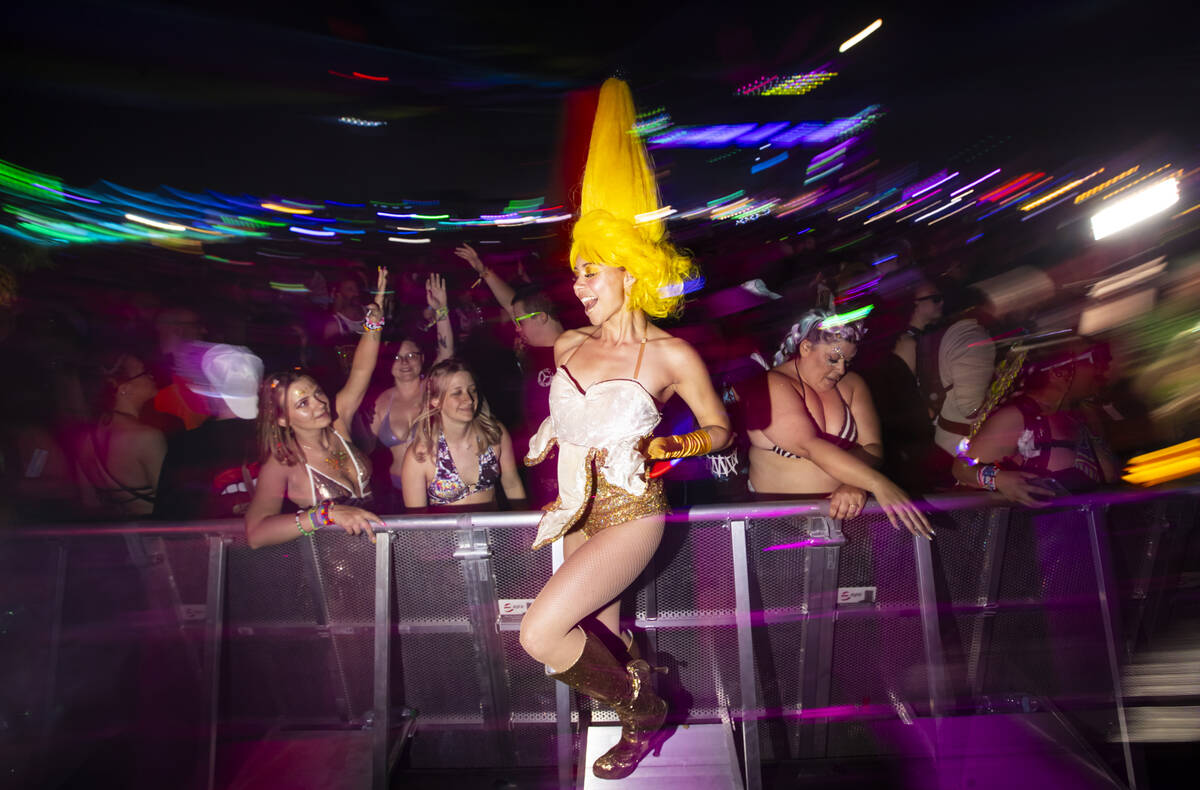 A costumed performer dances with the crowd at Kinetic Field during the second night of the Elec ...