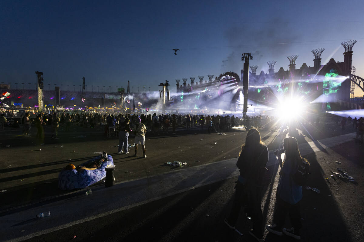 Festival attendees watch Kinetic Field as the sun begins to rise during the second night of the ...